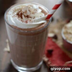 Nutella Power Shake 2 A cup of nutella milkshake topped with whipped cream and chocolate syrup.