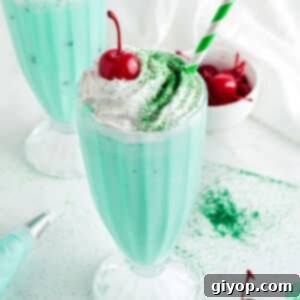 A close up image on a tall glass with shamrock shake.