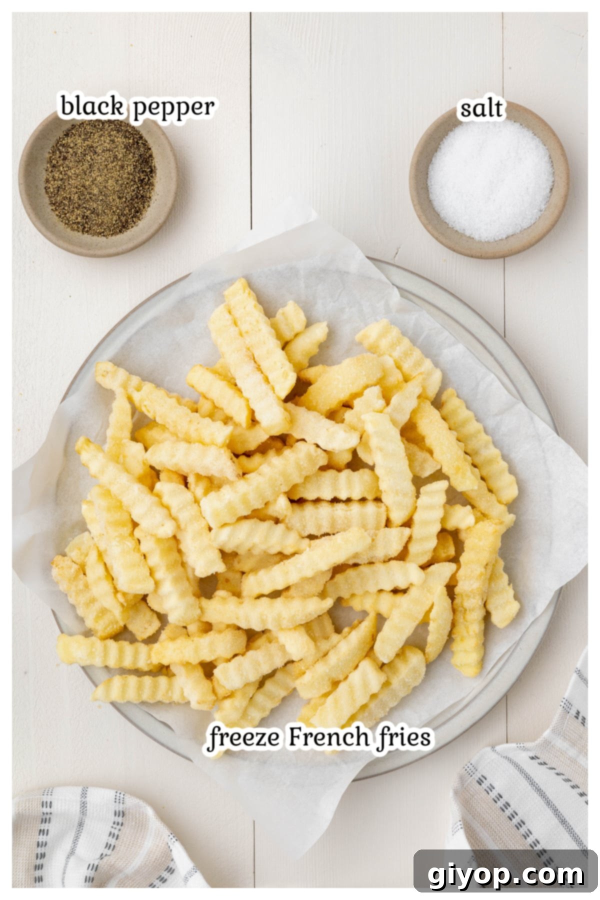 Ingredients for the french fries recipe on a wooden board.