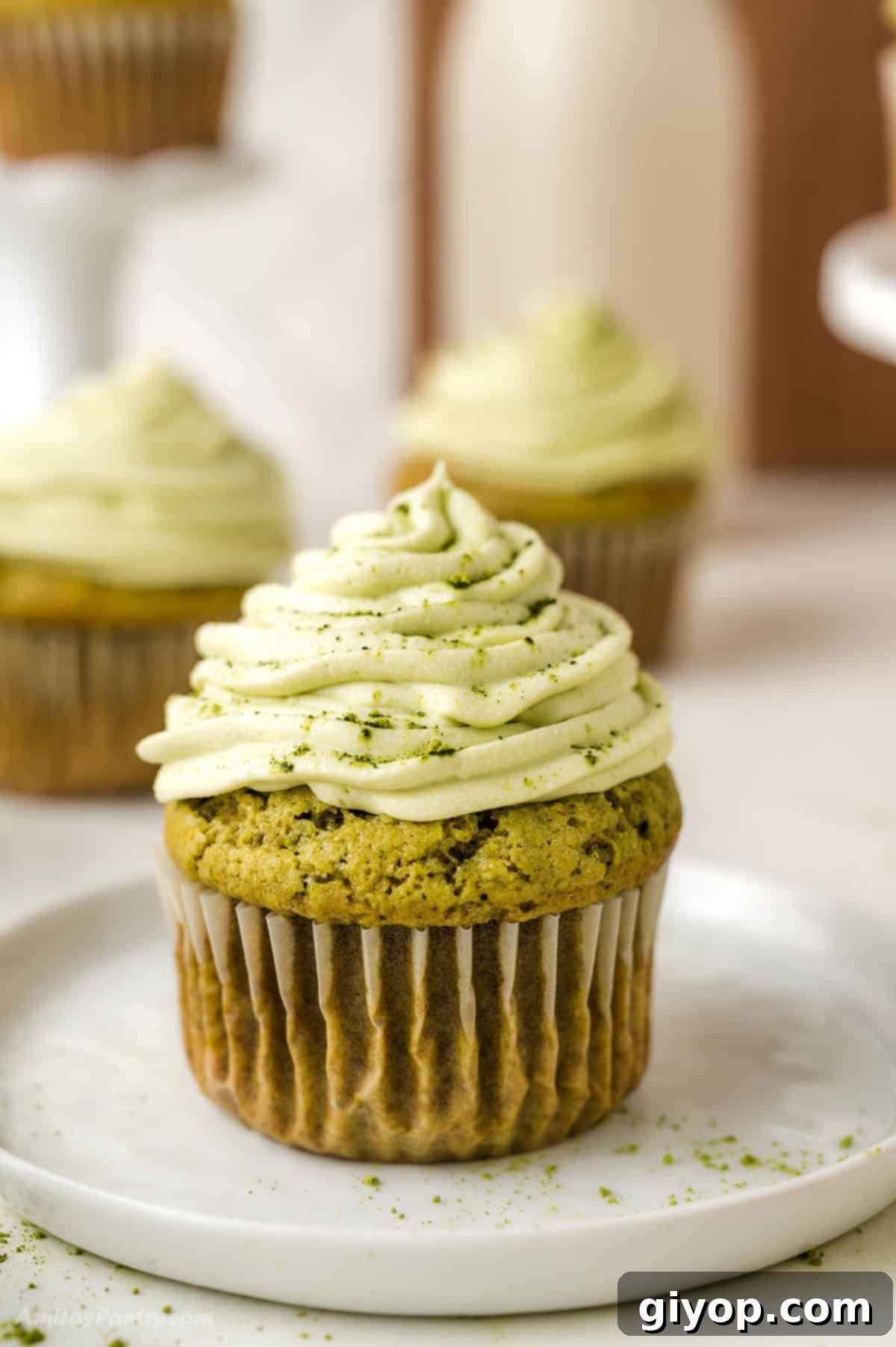One matcha cupcake on a white dessert table.
