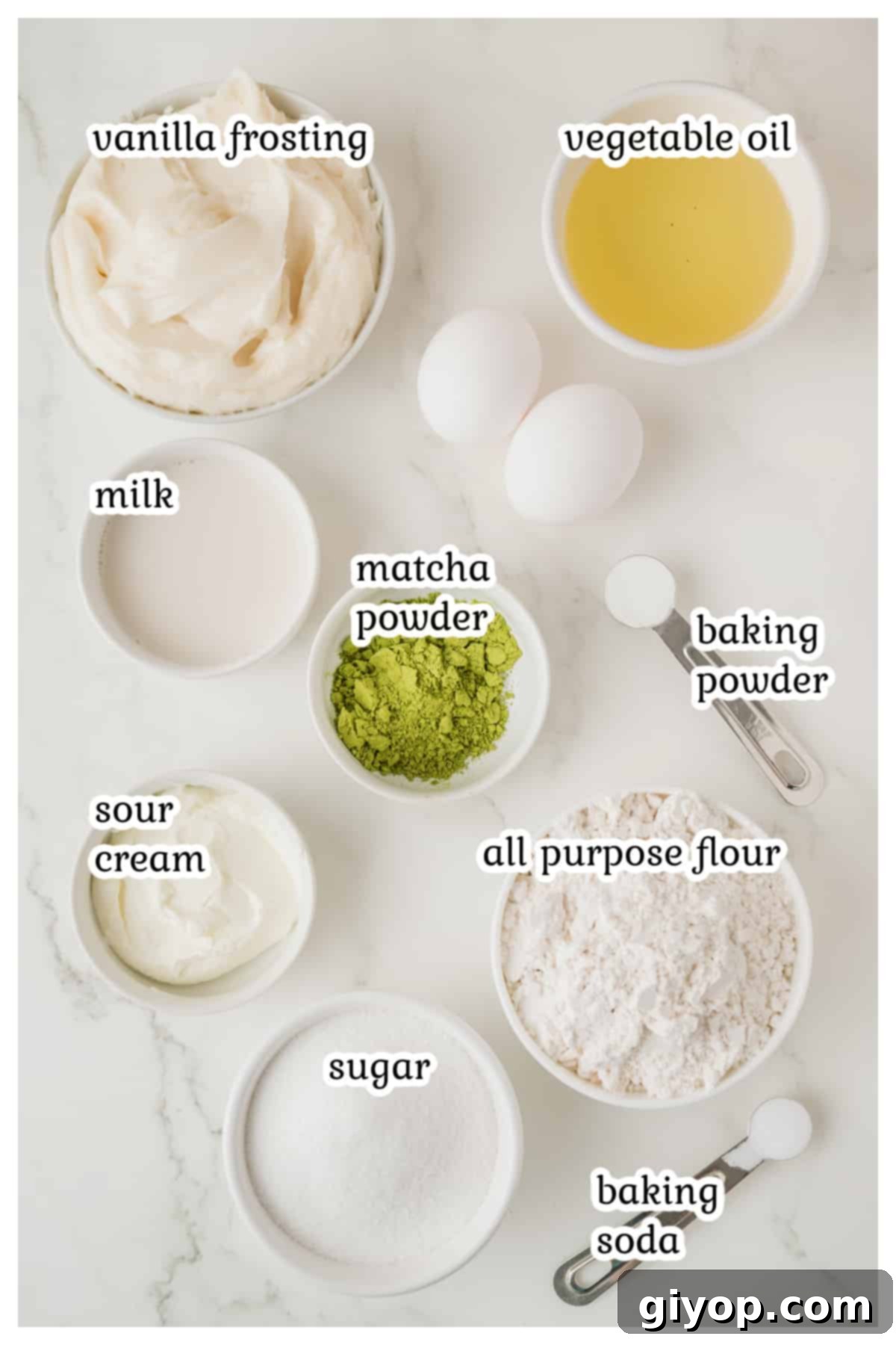 Ingredients for the matcha cupcakes on a white surface.