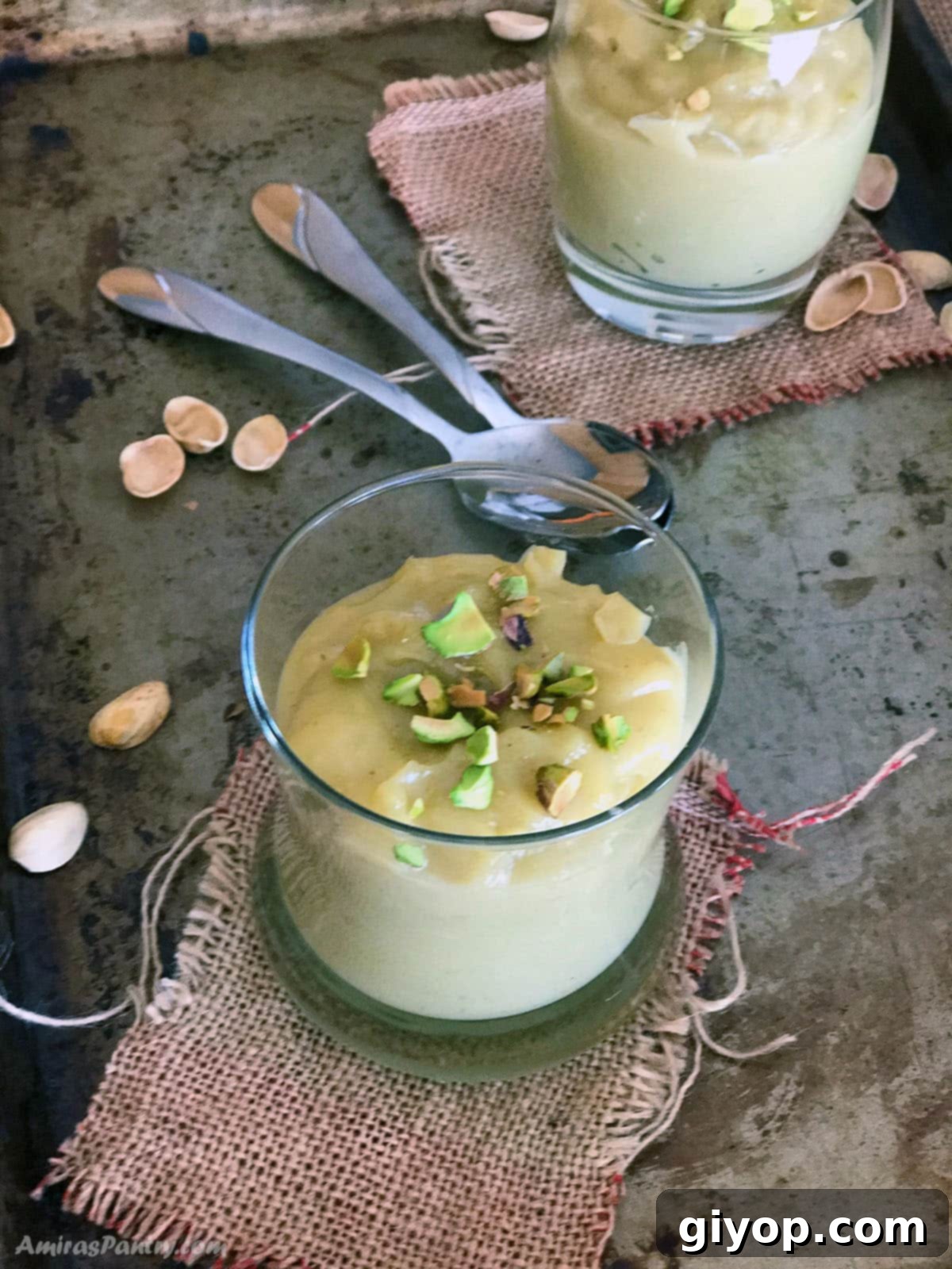 Velvet Pistachio Delight 5 A smooth and enticing serving of homemade pistachio pudding resting on a cool, minimalist metal surface, illuminated to highlight its rich texture and natural color, ready to be enjoyed as a refreshing dessert.