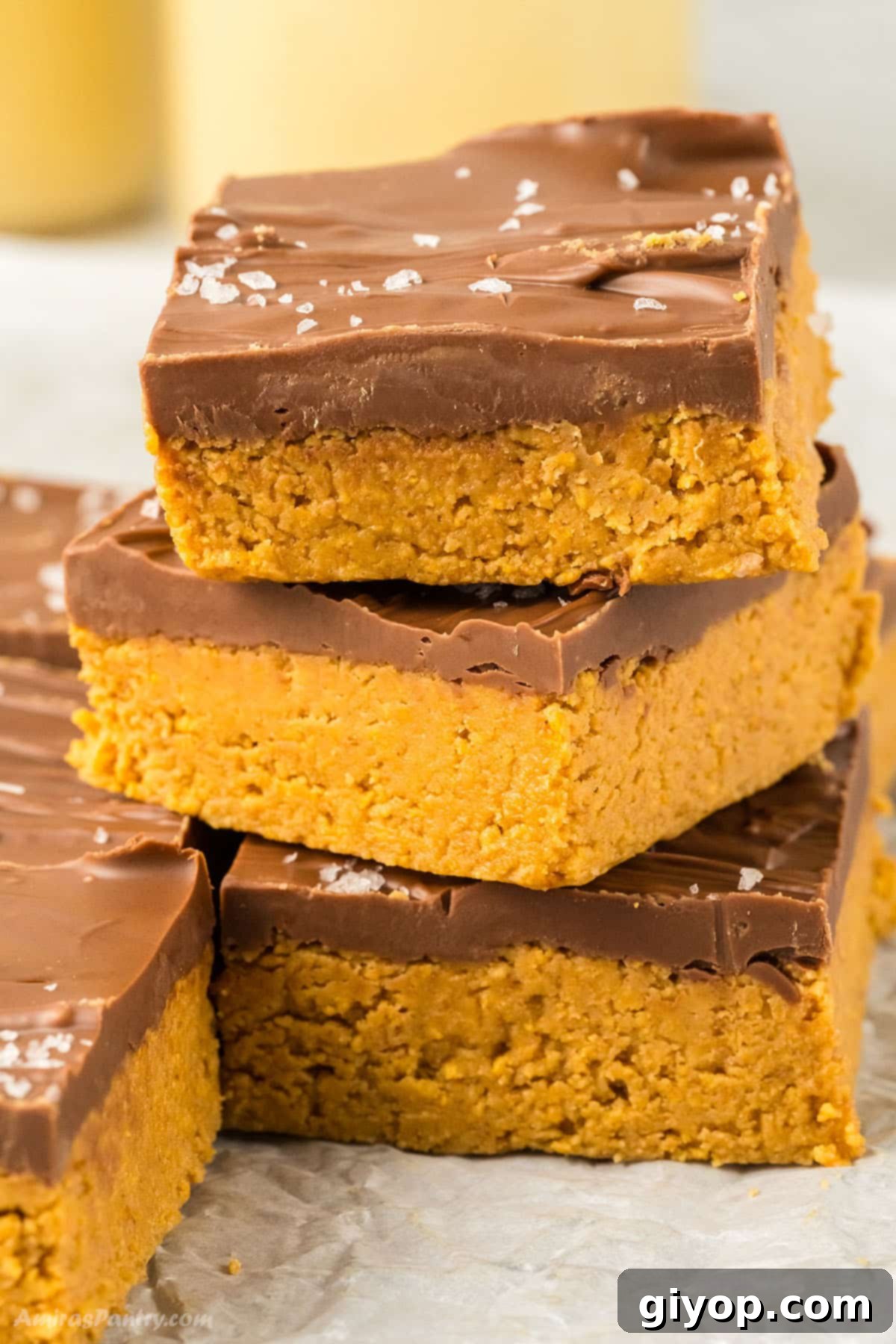 A close up image on a stack of peanut butter bars, highlighting their delicious layers.