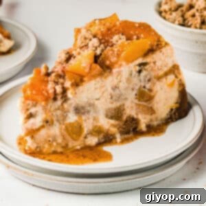 A slice of peach cheesecake on a dessert plate.