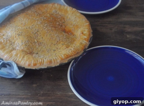 A slice of chicken shawarma pie on a plate, showcasing the filling and golden crust.