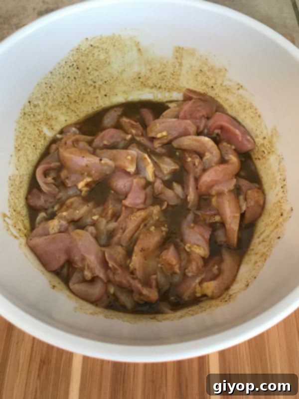 Chicken strips soaking in the aromatic shawarma marinade.