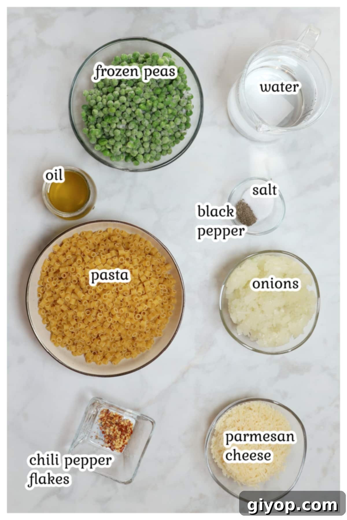 Creamy Pasta with Peas 3 A selection of fresh ingredients including ditalini pasta, olive oil, onion, red pepper flakes, frozen peas, and parmesan cheese, laid out for a Pasta e Piselli recipe.