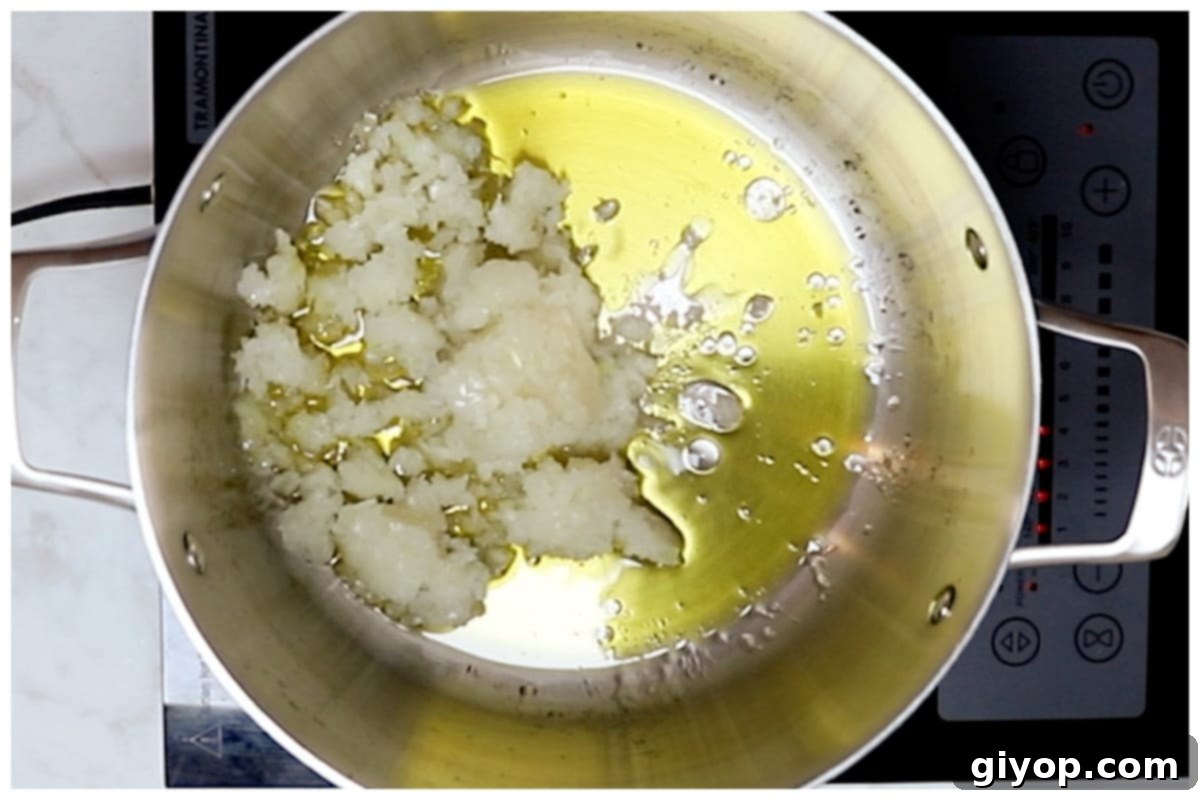 Creamy Pasta with Peas 4 Finely chopped onion being sautéed in extra virgin olive oil in a large pot, forming the aromatic base for Pasta e Piselli.