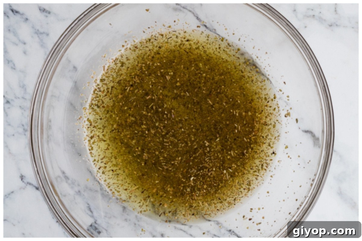 Sun-Kissed Caprese Chicken Sandwich 6 Marinade ingredients mixed in a large bowl, ready for the chicken.