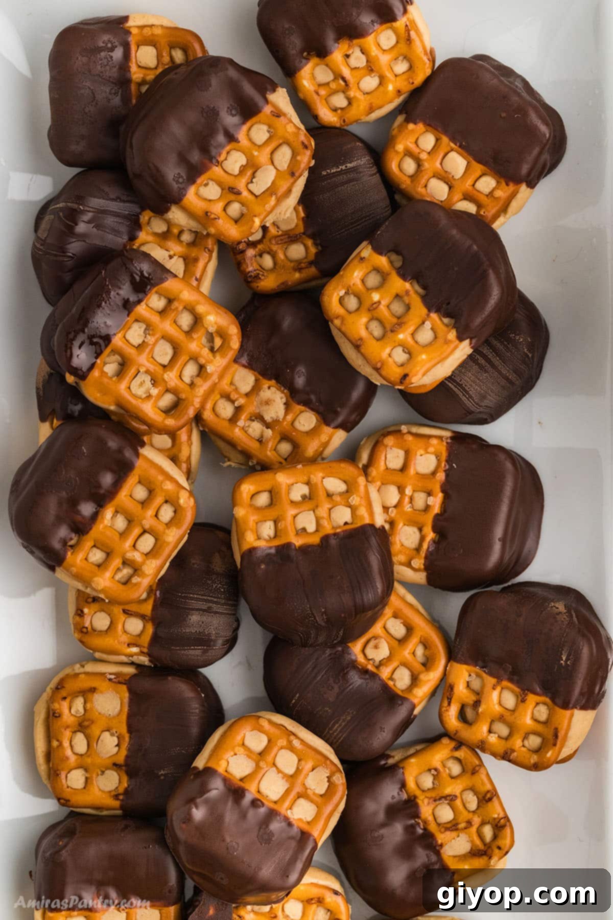 Pretzel bites dipped in chocolate on a serving platter.