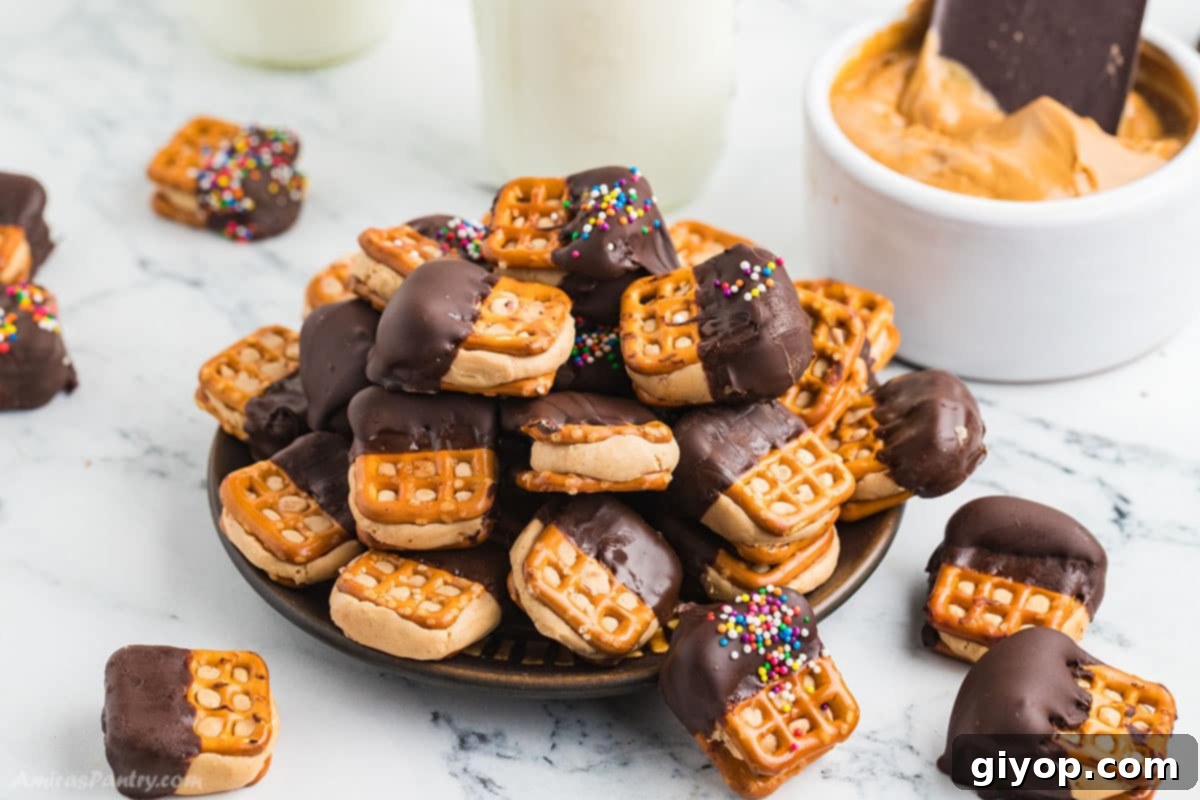 A pile of peanut butter pretzel sandwiches on a serving plate.