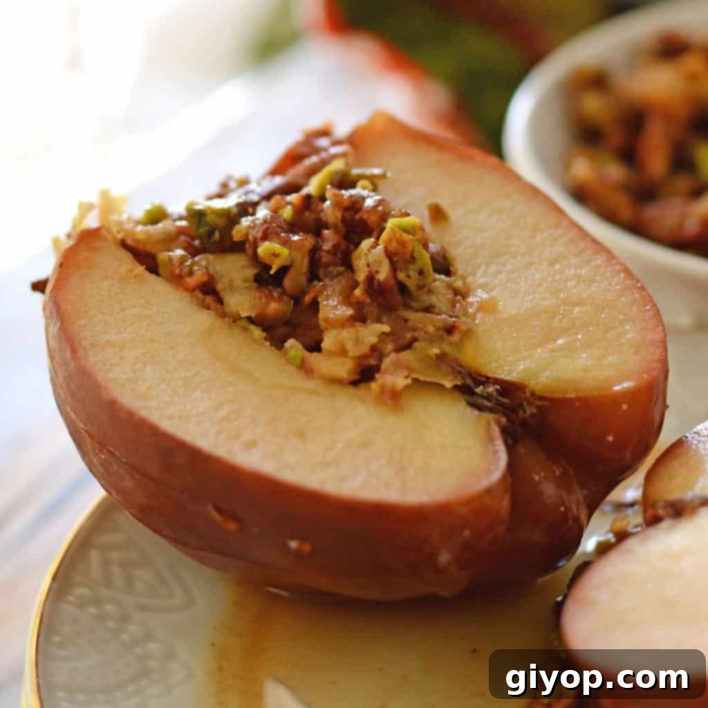 Stuffed apples with nuts placed on a white plate, showcasing a golden brown phyllo topping.