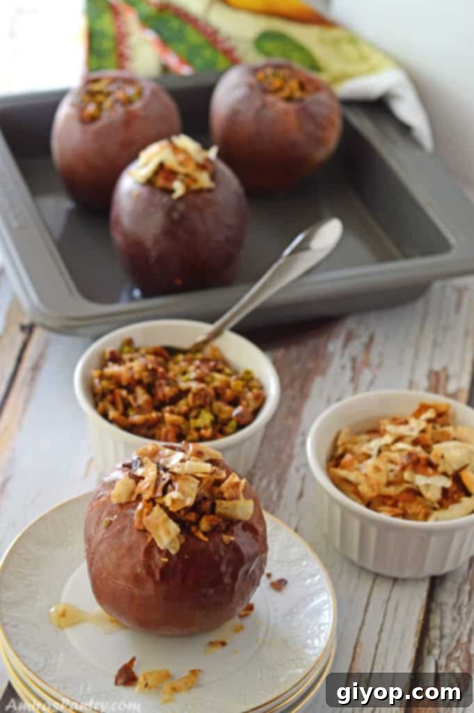 Baked apples on a wooden table, accompanied by bowls of nuts and baked phyllo dough pieces.