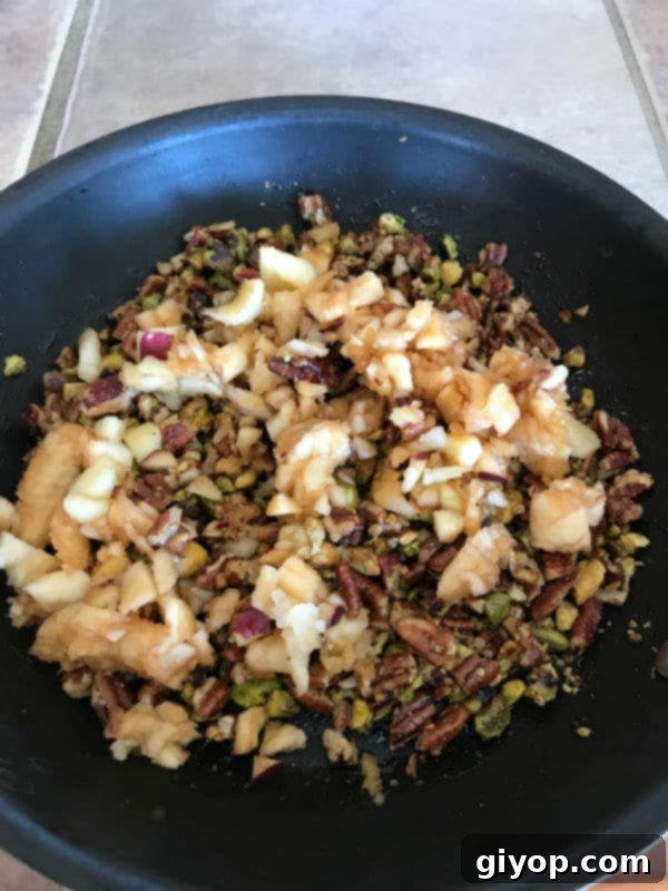 A bowl filled with apple pieces and the prepared nut mixture, ready to be stuffed.