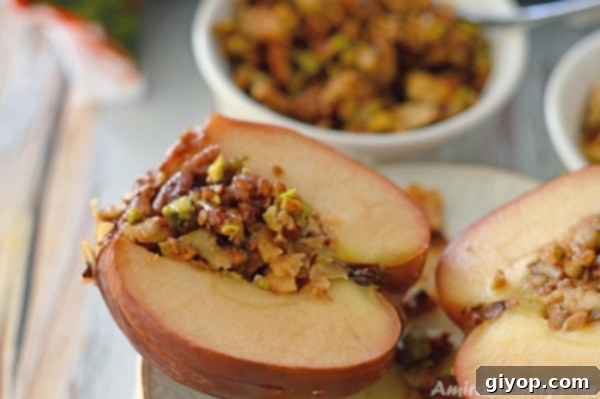 A plate featuring a perfectly baked Baklava Baked Apple, garnished with shredded phyllo and nuts.
