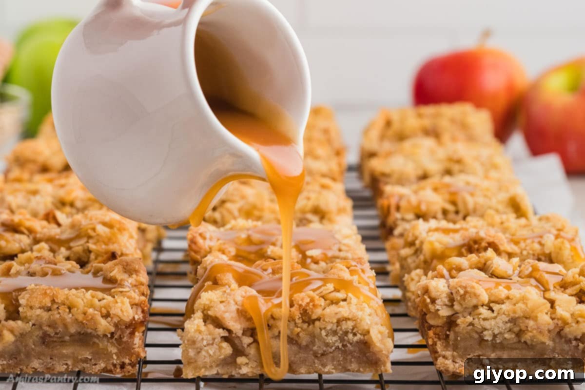 Decadent Salted Caramel Apple Pie Bars 4 A close-up shot of rich, golden salted caramel sauce being generously poured over a batch of freshly baked apple pie bars, highlighting their inviting texture and delicious topping.
