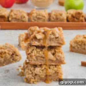 Decadent Salted Caramel Apple Pie Bars 5 Delicious apple pie bars with a glossy caramel sauce dripping down the sides, presented alongside fresh apples and autumn decor.