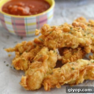 A close up of food on a table, golden chicken strips