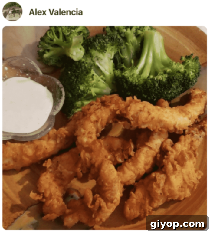 A beautifully arranged plate of crispy chicken strips, perfectly golden, made by a cooking enthusiast.