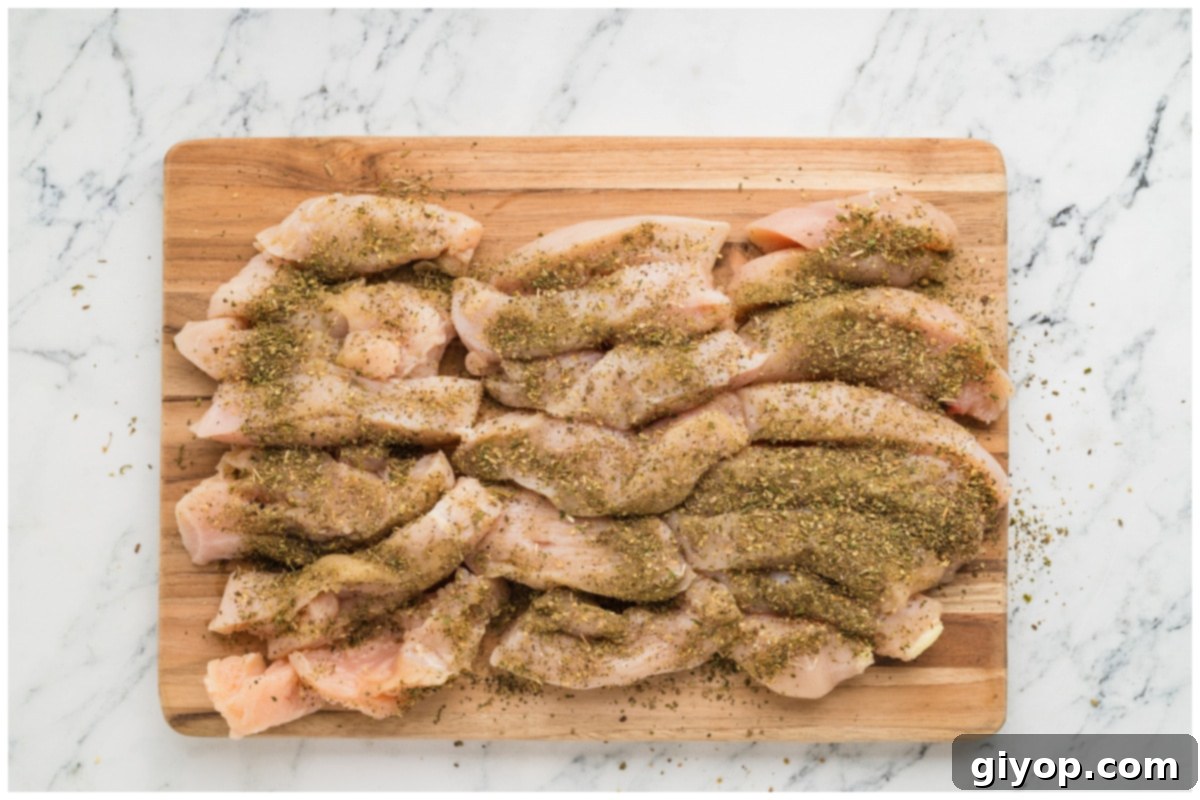 Bright Lemon Chicken Orzo 6 Tender chicken strips evenly seasoned with Mediterranean herbs and spices, ready for searing.