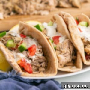 Set-It-and-Forget-It Chicken Gyros 4 A stack of chicken gyros sandwiches on a platter, ready to be served.