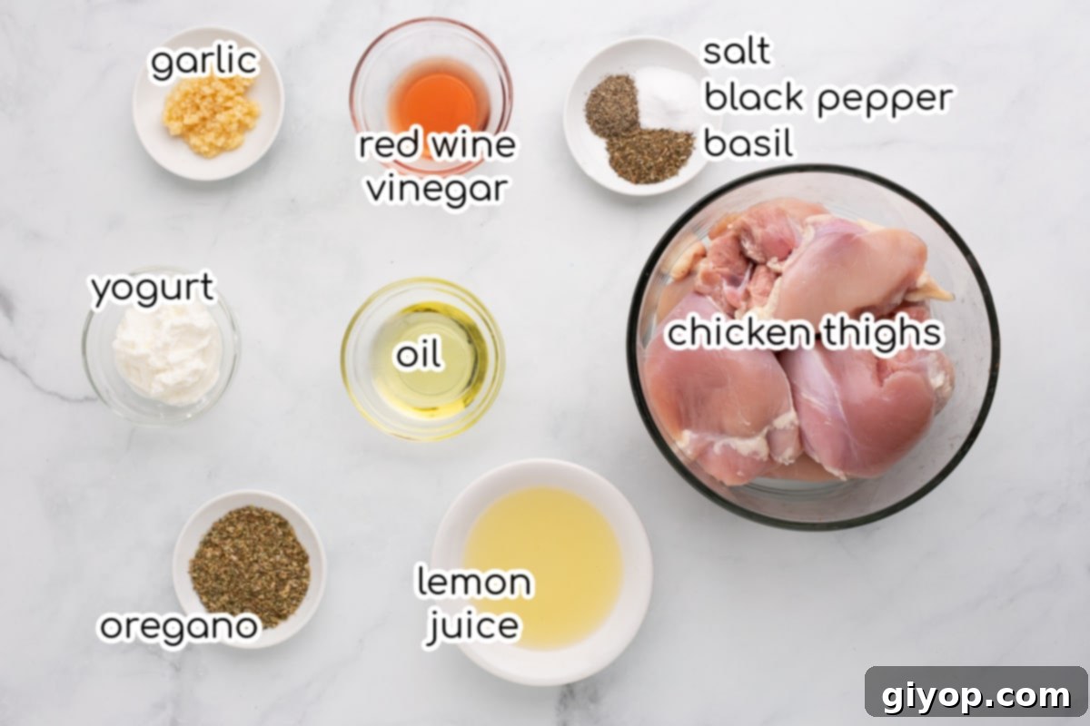 Set-It-and-Forget-It Chicken Gyros 5 Fresh ingredients laid out for Slow Cooker Chicken Gyros, including chicken thighs, spices, lemon, and yogurt.