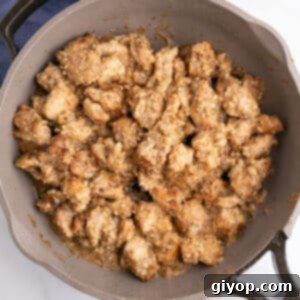 A large skillet with cooked chicken thighs in garlic butter sauce.