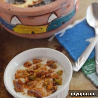 A bowl of food on a plate, and Rice Pudding on a spoon