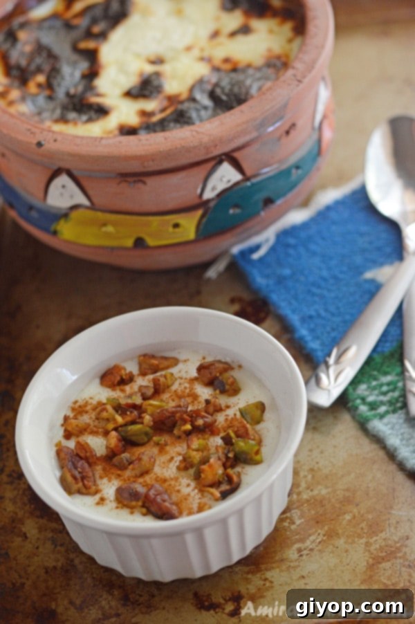 A cup of food on a table, with Rice Pudding and nuts