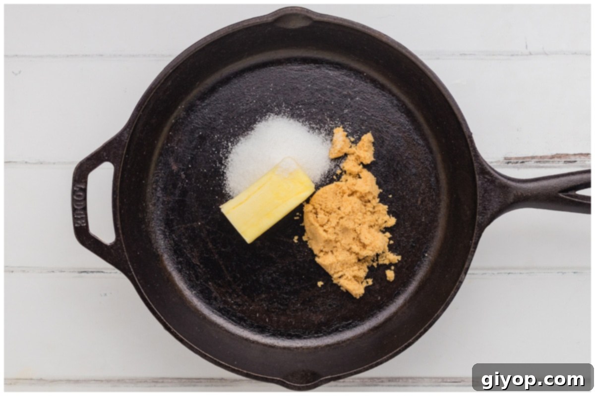 A close-up shot of a skillet on medium heat, with butter and both brown and white sugars melting together to form a sweet glaze.