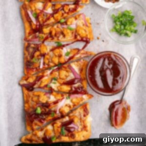 An overhead image of slices of flatbread pizza with bbq sauce.
