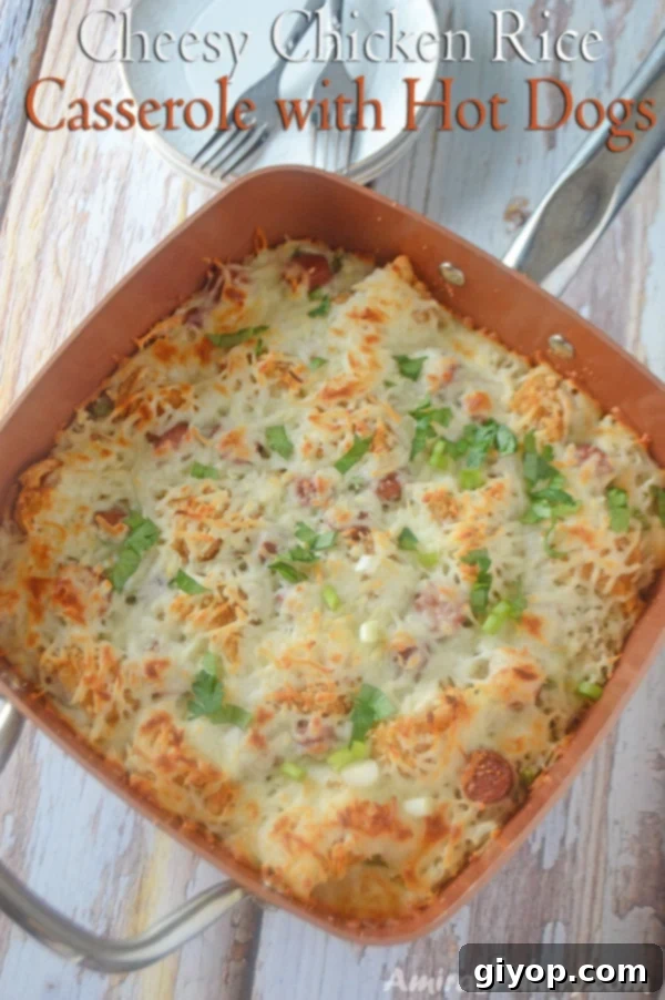A pot with rice, melted cheese, and chicken on a rustic wooden table, ready to be served as a family dinner.