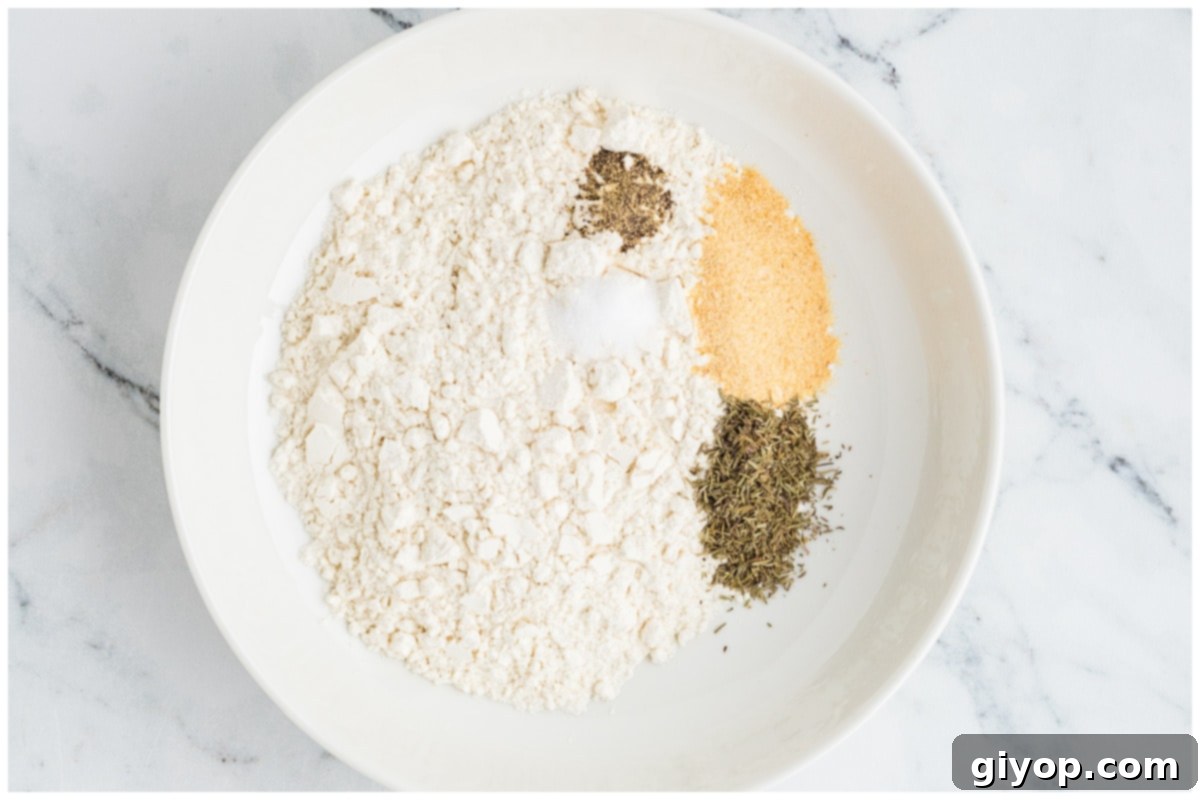 A white bowl containing the perfectly blended spice and flour mixture for coating the chicken.