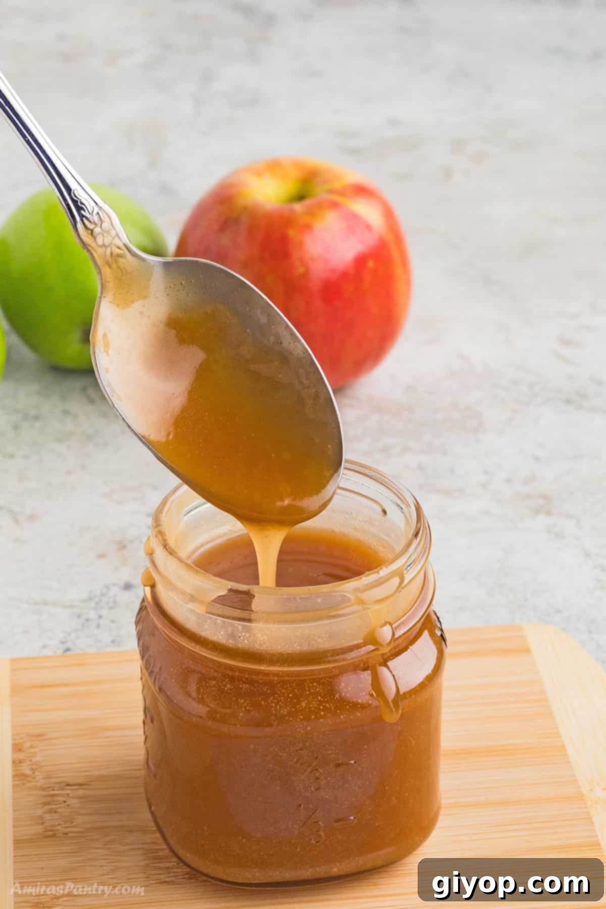Glossy, golden homemade caramel sauce drizzled beautifully, ready for any dessert.