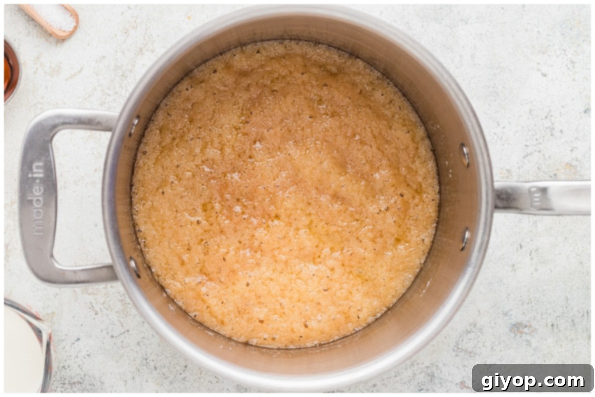 Caramel mixture bubbling gently in a saucepan, turning golden brown.