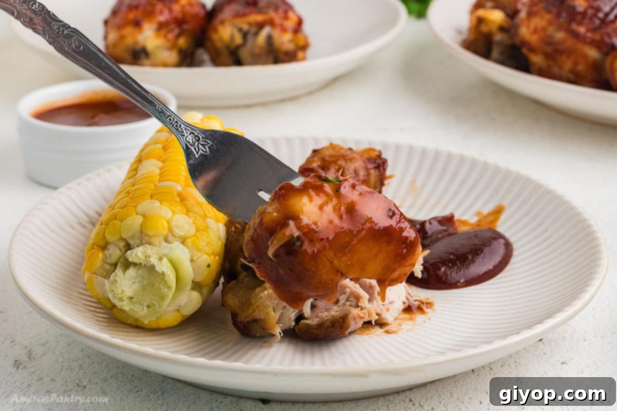 A tender slow cooker chicken drumstick served with fresh corn on the cob.