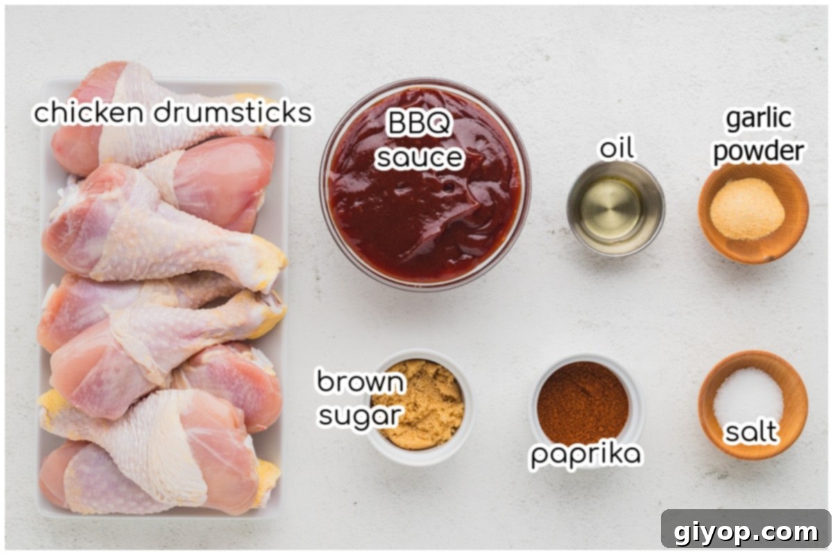 A selection of fresh ingredients including chicken drumsticks, spices, and olive oil for the slow cooker recipe.