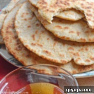 Middle Eastern Flatbread Heritage 2 A stack of flatbread on a blue plate with a small bowl of honey.