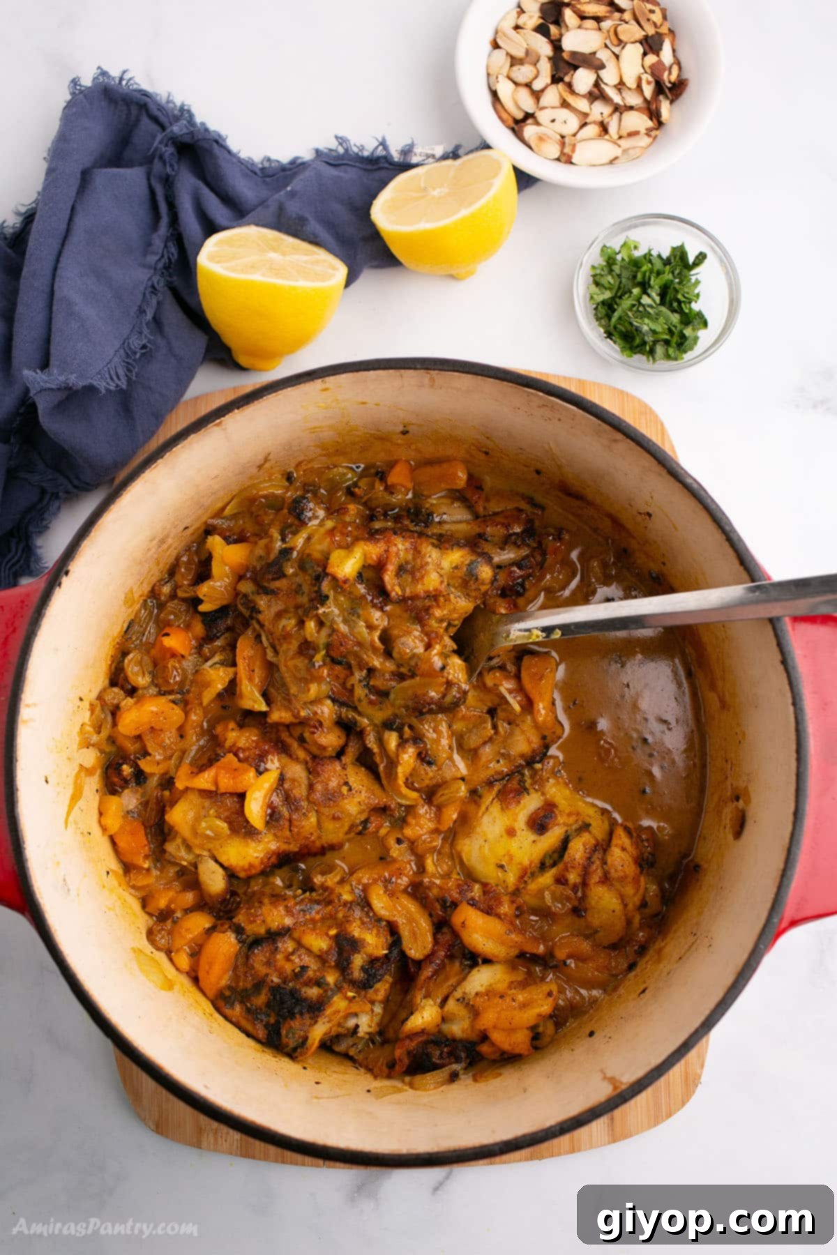 An overhead image of a deep pot with chicken tagine, showcasing tender chicken, sweet apricots, and a rich, spiced sauce, ready to be served.