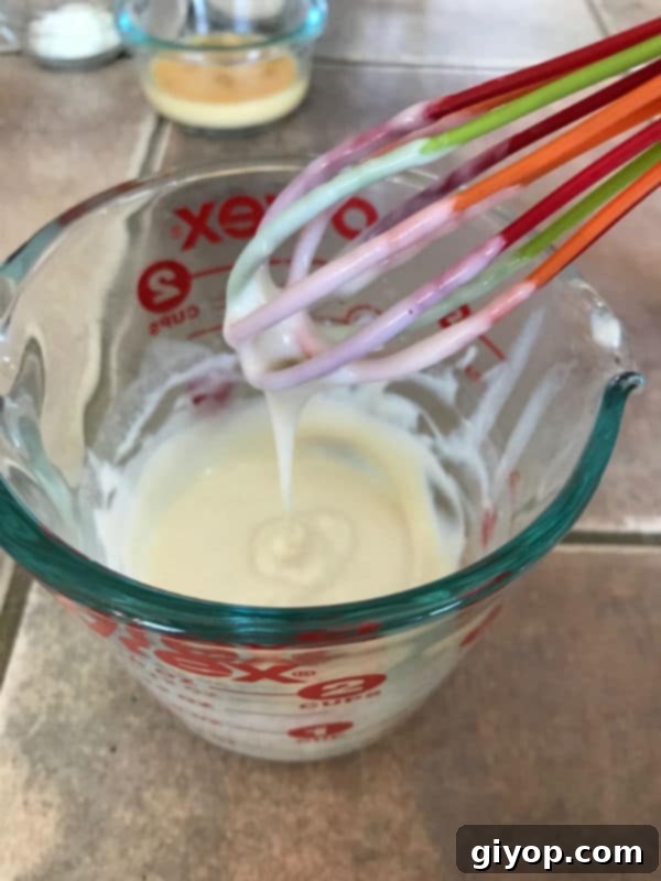 A measuring cup containing the flour and milk mixture for the Tangzhong method.