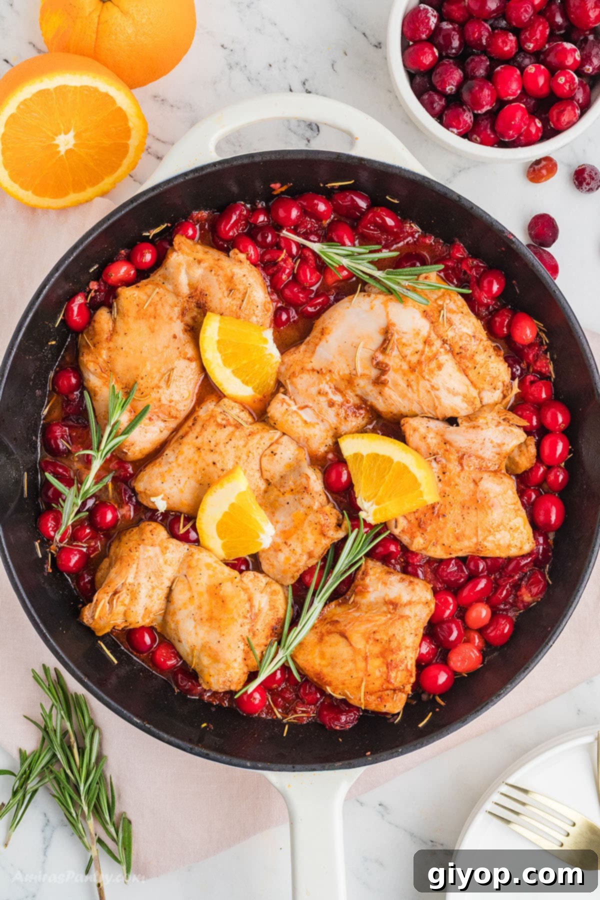 Zesty Cranberry Orange Chicken 2 Cranberry chicken with orange slices on a large skillet.