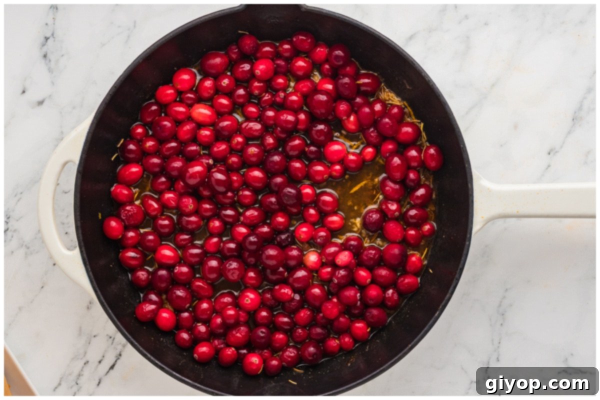 Zesty Cranberry Orange Chicken 8 A skillet with cranberry sauce.