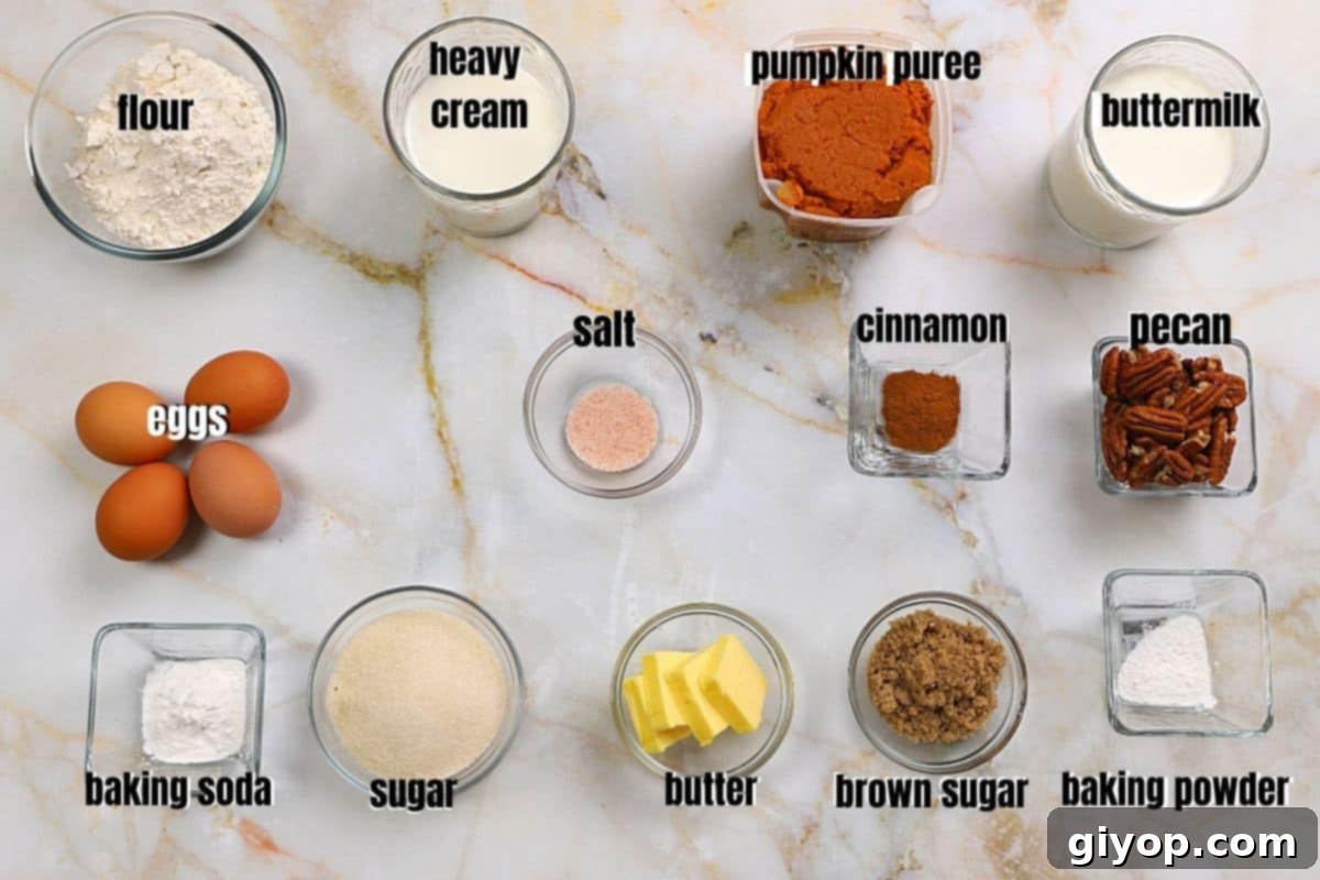 A flat lay of various ingredients for pumpkin pecan cake, including pumpkin puree, butter, flour, sugar, and pecans, arranged on a rustic tabletop.