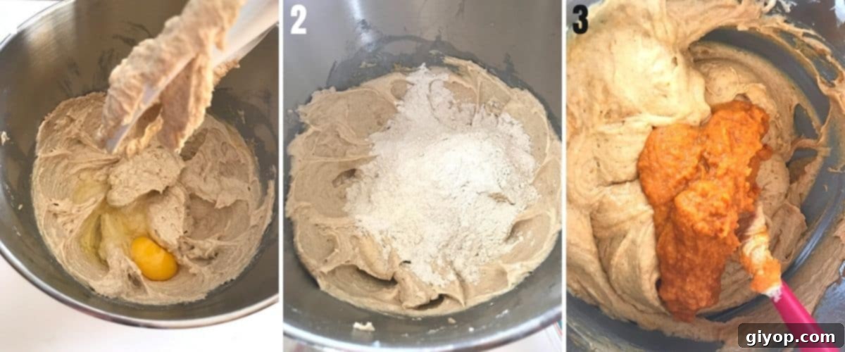 The cake batter, now with eggs added one by one, being beaten in a stand mixer.