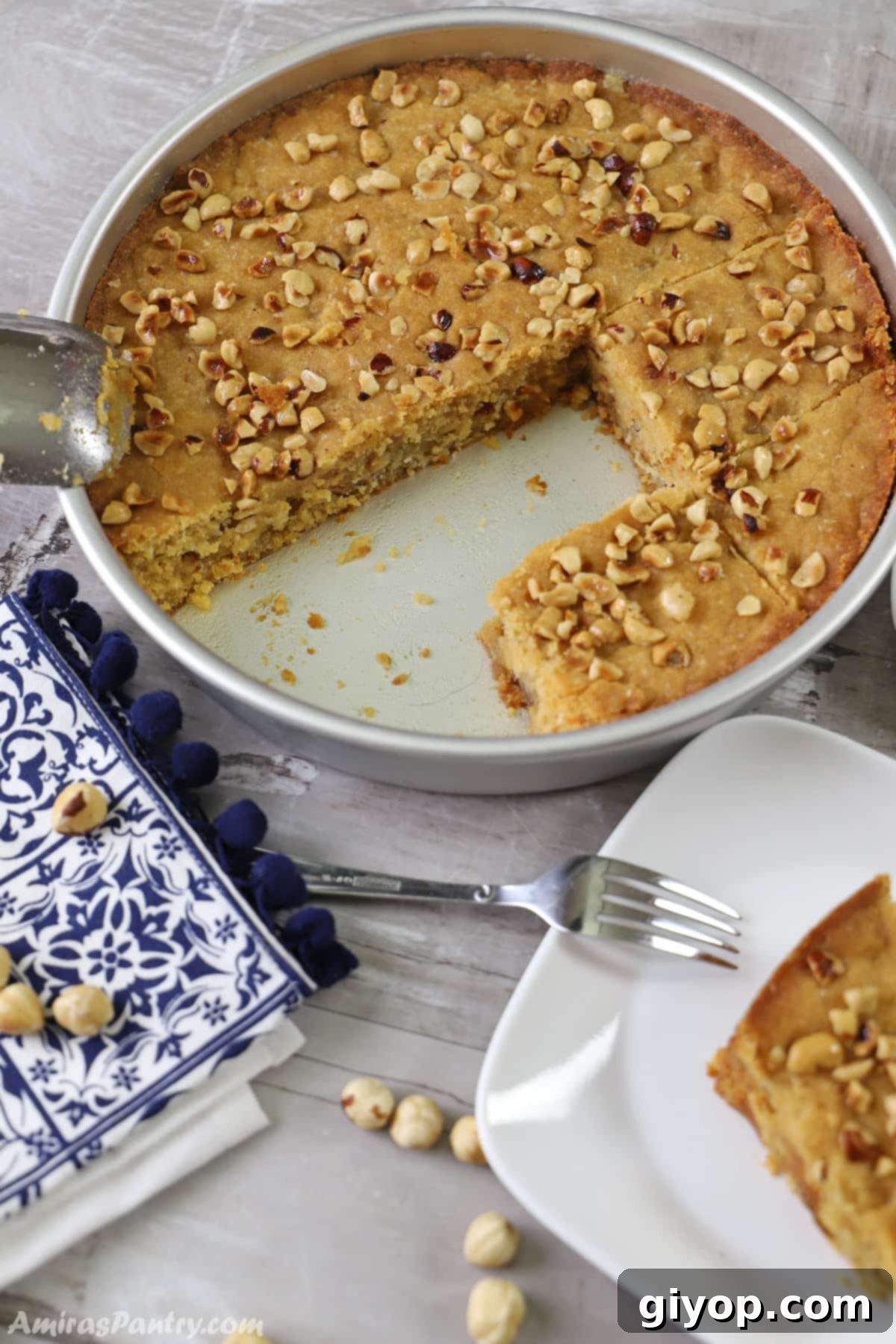 Harissa: Egypt's Fiery Secret 7 A harissa tray with some parts cut out of it and a blue and white kitchen towel on the side.