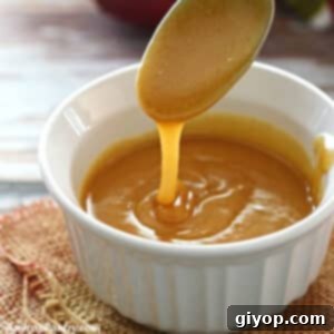 Velvet Date Caramel 8 A spoon pouring some date caramel into a white bowl.