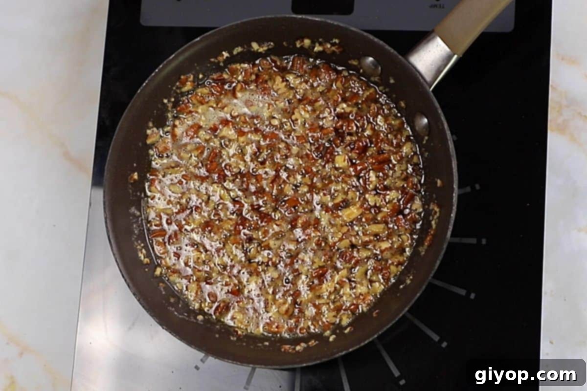 An appetizing image showcasing the final maple pecan syrup glaze being poured over a freshly baked sweet potato casserole.