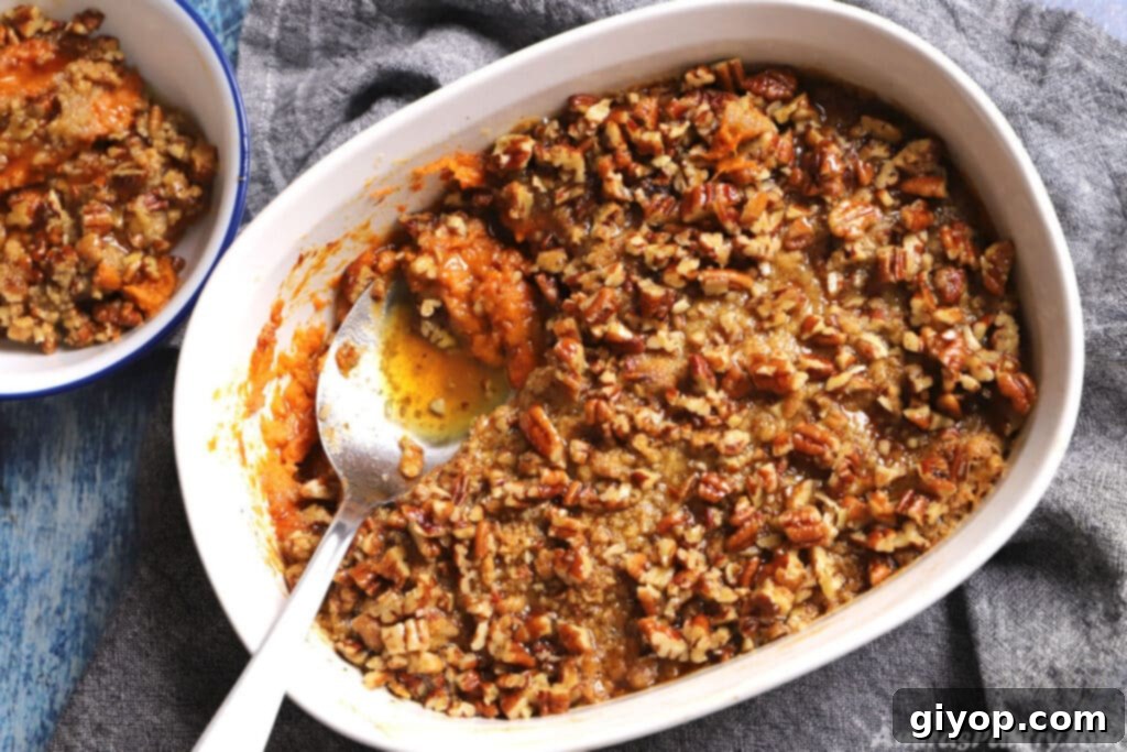 Overhead photo of a perfectly baked sweet potato crunch casserole in a elegant white dish, ready to be served.