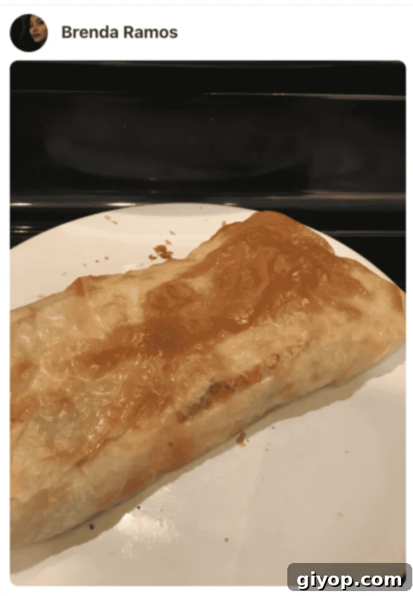 A close up of freshly baked Feteer Meshaltet topped with butter on a white plate