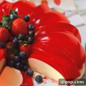 Dreamy Cream Cheese Jello Dessert 3 A close up photo of cream jello Cake on a plate